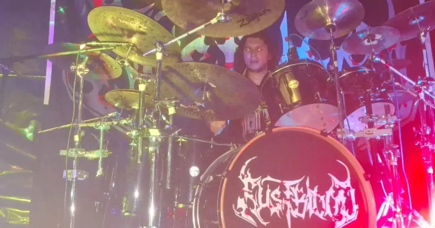 Alan Gómez on drums with the Rustblood logo on the bass drum
