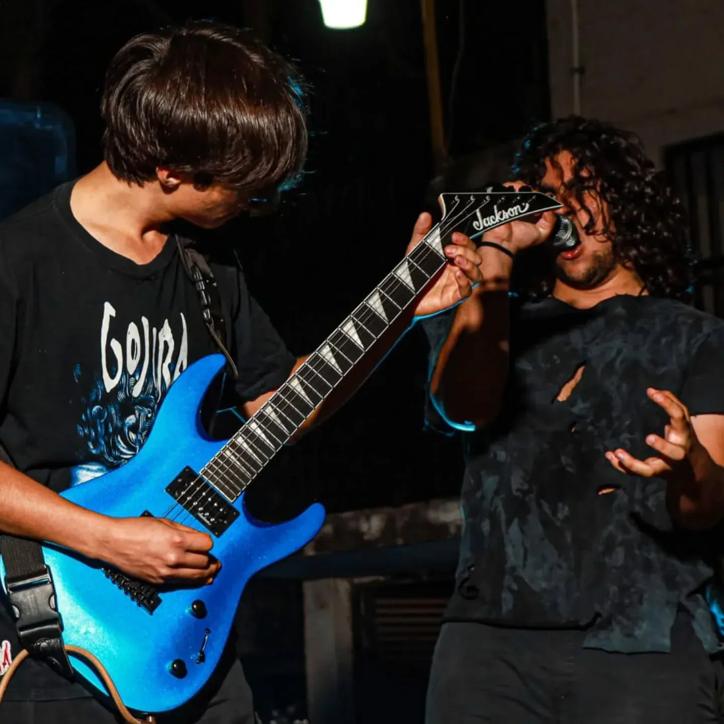 Rustblood guitar and vocals sharing the mic at a night show